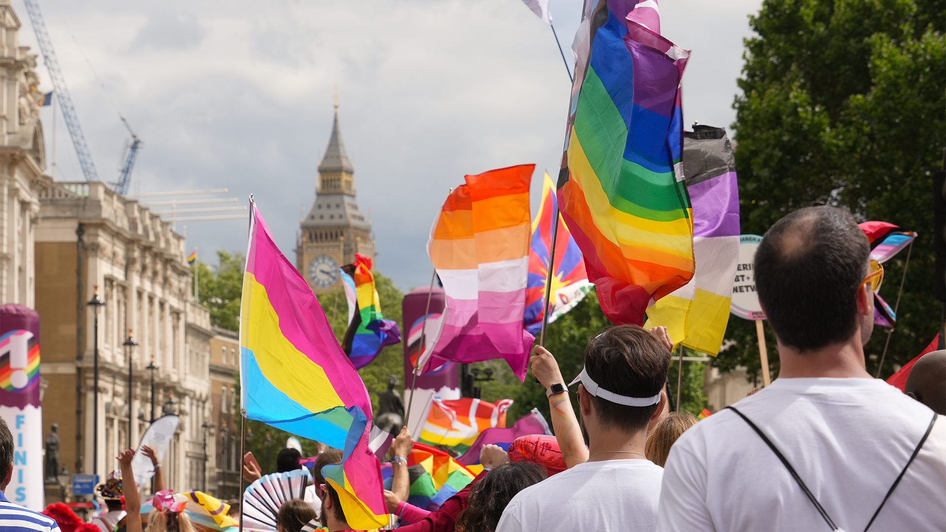 Celebrate London's LGBTQ+ community at the Pride in London Parade. Image courtesy of London & Partners/Peter Cohen. Rainbow-coloured flags are waved by people during Pride in London.
