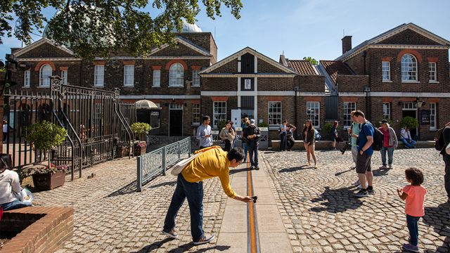 People standing by the Prime Meridian Line