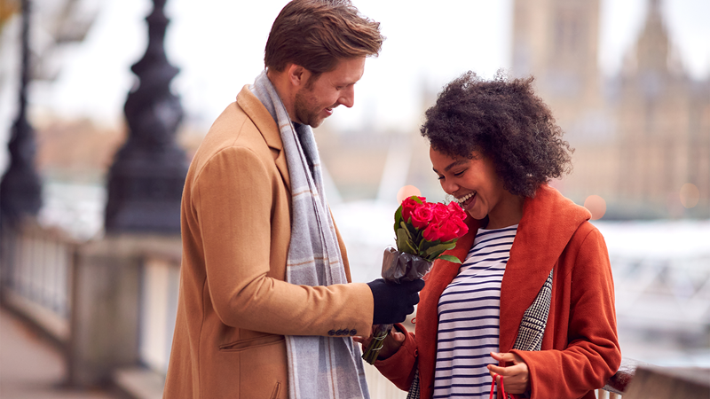 Woo your sweetheart with a romantic day out in London. Credit: Shutterstock. Image courtesy of Shutterstock. A man gives flowers to a woman outside of the Houses of Parliament in London on Valentine's Day.