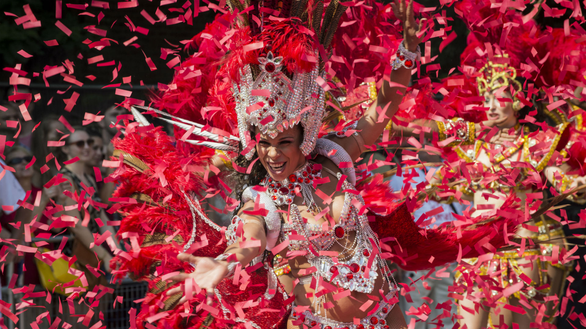 Notting Hill Carnival 2016. Image courtesy of Carnival Village Trust/Tara Hobson. A Notting Hill Carnival performer dances while surrounded by confetti