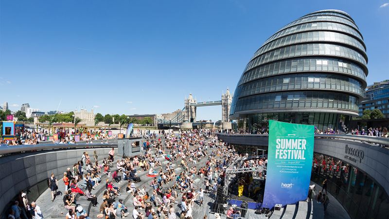 Make the most of Summer by the River in London Bridge. Image courtesy of London Bridge City. Crowds watch a performance during the Summer by the River festival at The Scoop.