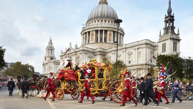 The Lord Mayor's Show, passing St Paul's Cathedral. Credit: The Lord Mayor's Show. Image courtesy of The Lord Mayor's Show. A golden carriage, manned by people in traditional red livery, passes in front of St Paul's Cathedral.