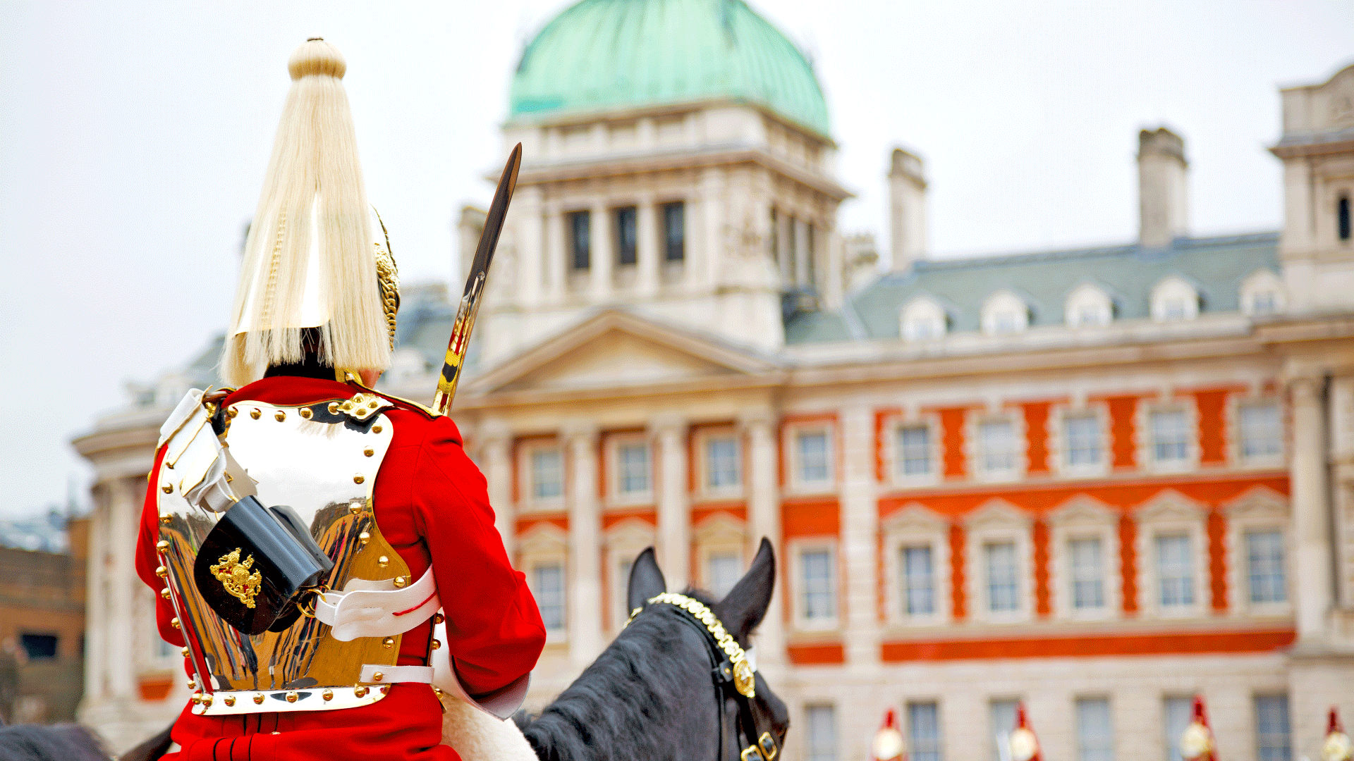 Admire the pomp and pageantry of the Trooping the Colour parade. Credit: Shutterstock. Image courtesy of Shutterstock. Horseguard sits on top of black horse in front of the Horseguards Parade