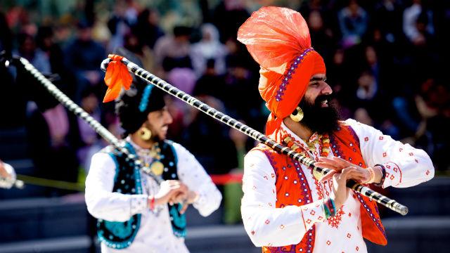 Vaisakhi Festival in Trafalgar Square. Image courtesy of Greater London Authority Two men stand dressed in traditional Vaisakhi Festival outfits in trafalgar square.