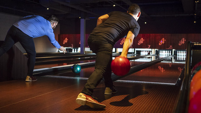 Get friends together to bowl at All Star Lanes. Image courtesy of All Star Lanes. Two men bowling at All Star Lanes bowling alley in London.