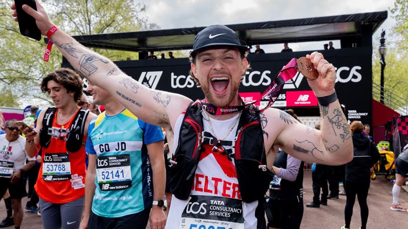 Tom Grennan, singer/songwriter, celebrates with his medal after finishing The TCS London Marathon on Sunday 21st April 2024.