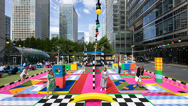 Putt your way around the colourful course at Canary Wharf. Image courtesy of The Academy PR. A group of women putt their way around a colourful mini-golf course at Canary Wharf on a sunny day
