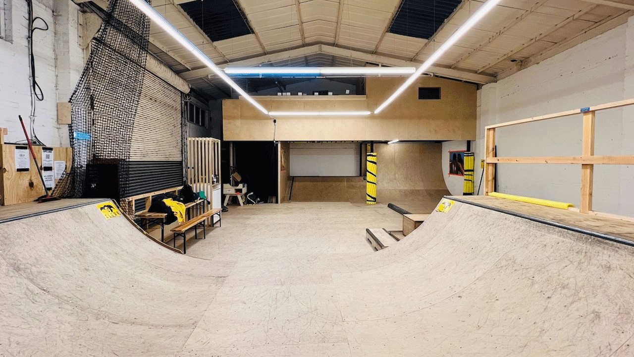 Skatepark at School of Skate. Credit: School of Skate Ltd. Image courtesy of School of Skate. LED lights glow above the ramp at School of Skate skatepark