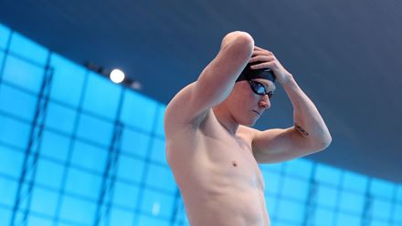 Thomas Dean secures his swim cap before a race. Image courtesy of Aquatics GB