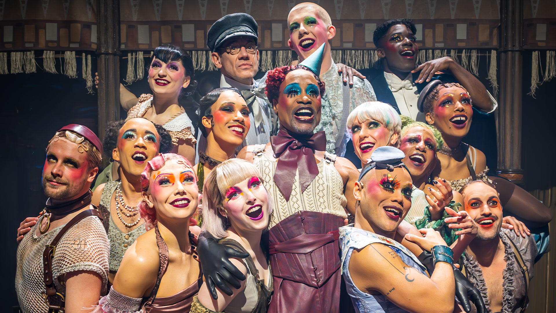 Enter the underground world of Cabaret at the Kit Kat Club. Image courtesy of Raw PR/Mark Brenner. The troop of Cabaret at the Kit Kat Club take the pose on the Playhouse theatre stage and are standing under the light wearing costumes of all style.