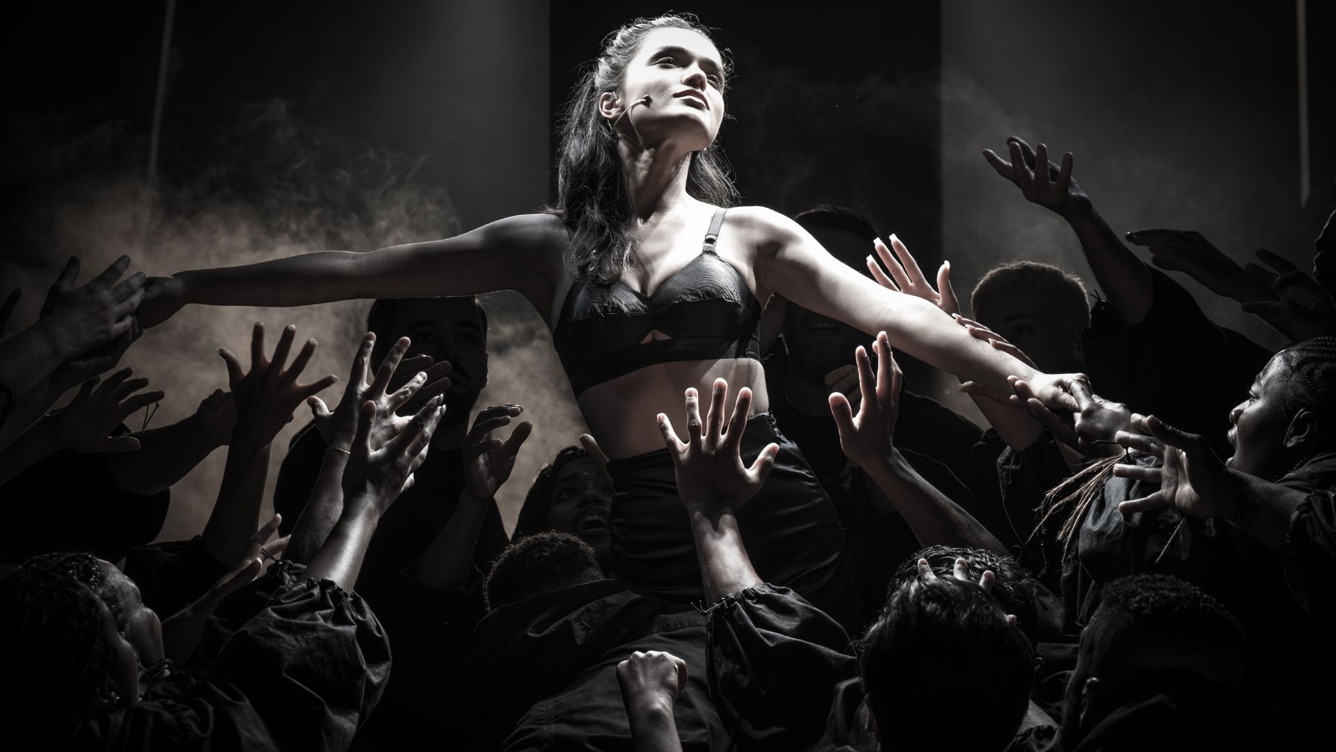 Watch the spectacular revival of Evita, the iconic musical about the life of Argentinian first lady Eva Perón. Image courtesy of London Theatre Direct. Rachel Zegler, who plays the lead role in Evita, is shown with her arms raised in the air, while the other cast members raise their hands towards her.