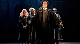 The actress, who plays Rose Weasley in Harry Potter and the Cursed Child, wears the Hogwarts uniforms and stands proudly on stage, smiling as classmates stand behind her.