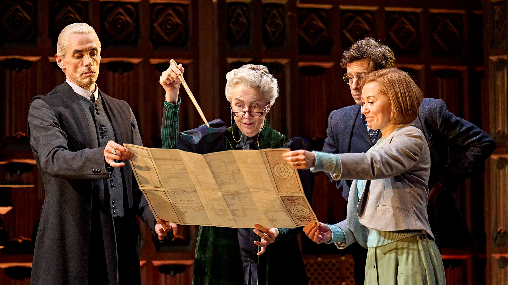 See wizardry at its finest at London's Palace Theatre this season as wizards, spells and the dark arts make a comeback in Harry Potter and the Cursed Child. ©London Theatre Direct The actors playing the Potters and the Malfoys in Harry Potter and the Cursed Child are holding a map trying to figure out some sort of problem.