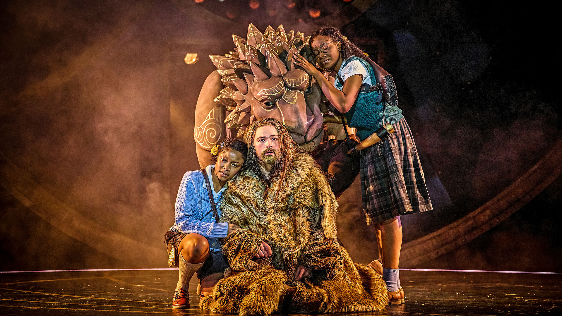 The Lion, The Witch and The Wardrobe at Sadler's Wells. Image courtesy of Brinkhoff-Moegenburg. The actresses who play Lucy and Susan in The Lion, the Witch and the Wardrobe stand by Aslan, the actor's life-size puppet representing the lion.