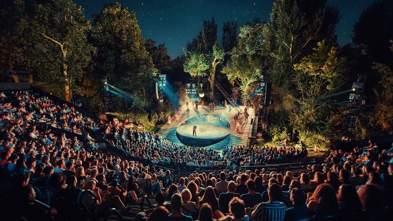 Watch a play under the stars at the Regents Park Open Air Theatre. Credit: David Jensen. Image courtesy of Feast Creative Web. The Open Air Theatre in Regent's Park is filled with spectators at night watching one of the performances programmed.