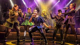 Tudor queens are dressed with sequin modern dresses performing on the stage of the Vaudeville Theatre.