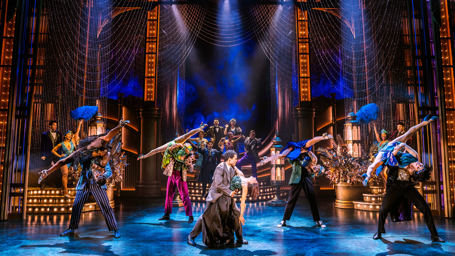 Experience one of Jay Gatsby's luxurious parties for yourself at The Great Gatsby musical (Broadway production). Image courtesy of London Theatre Direct. Photo credit: Matthew Murphy and Evan Zimmerman. A number of couples dance in unison during a performance on a lit stage.