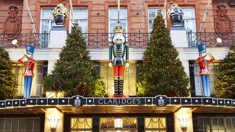 The exterior of Claridge's dressed up with Christmas decorations, including Christmas trees, a nutcracker and soldiers.