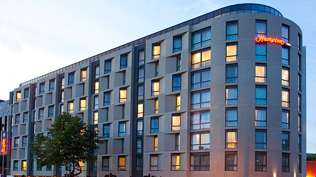 The exterior of Hampton by Hilton London Waterloo at dusk.