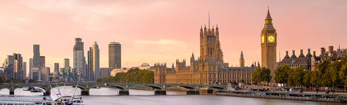 Views of Big Ben, the Houses of Parliament and the London skyline at sunset from the river Thames.