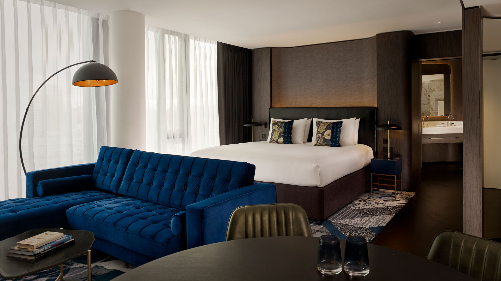 Discover the capital’s top sights nearby The Westminster London. Image courtesy of Hilton. Bedroom with dark blue sofa at The Westminster London.