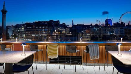 Unwind with a cocktail at The Trafalgar St. James' rooftop bar. Image courtesy of Hilton.