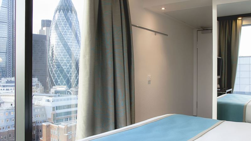 Marvel at the view of London's iconic financial district from Motel One Tower Hill. Credit: Weber Shandwick. Image courtesy of Weber Shandwick. A view of the Gherkin and other high rise buildings from a modern hotel room