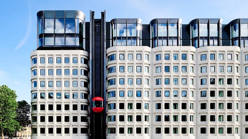 A shot of The Standard, London hotel's Brutalist building and iconic exterior red lift.